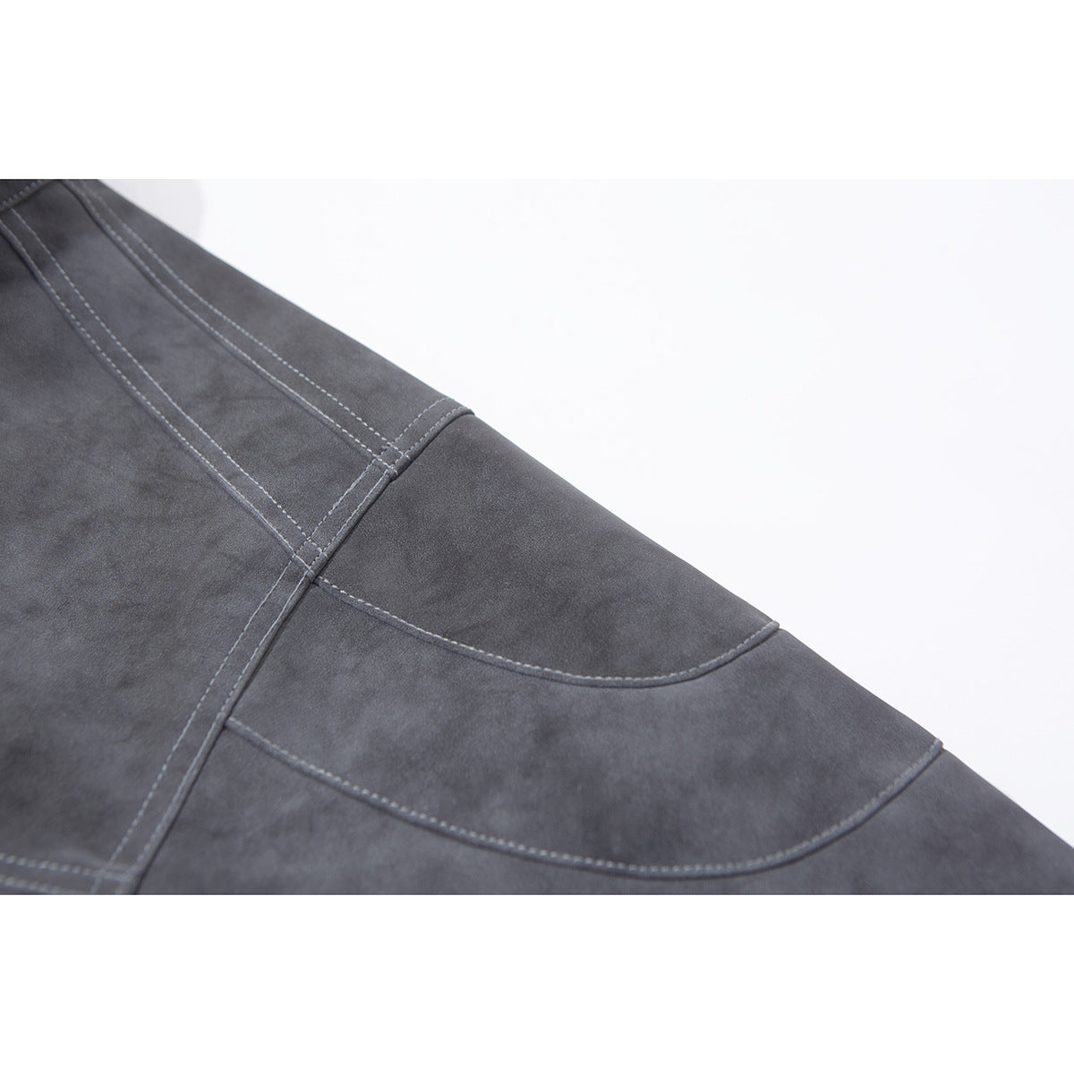 Close-up of a charcoal gray jacket sleeve showing curved stitched panels and seams.