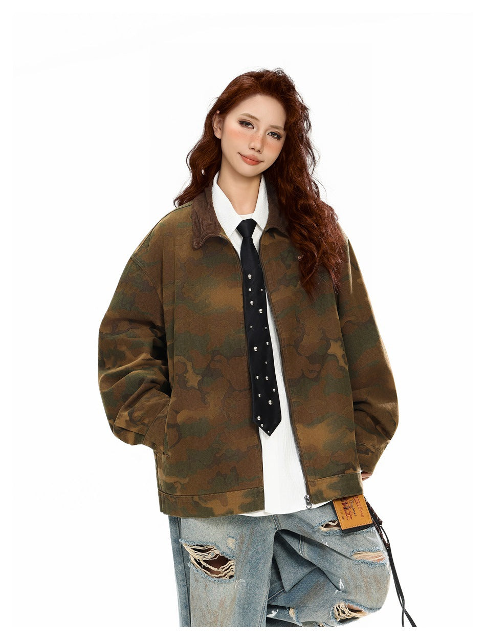 Model in an oversized brown and olive camouflage jacket with a dark collar, layered over a white shirt and black tie.