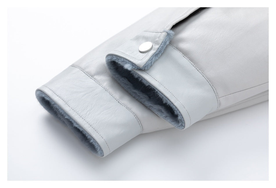 Pale gray jacket sleeve cuff showing soft gray lining and a snap-tab closure.