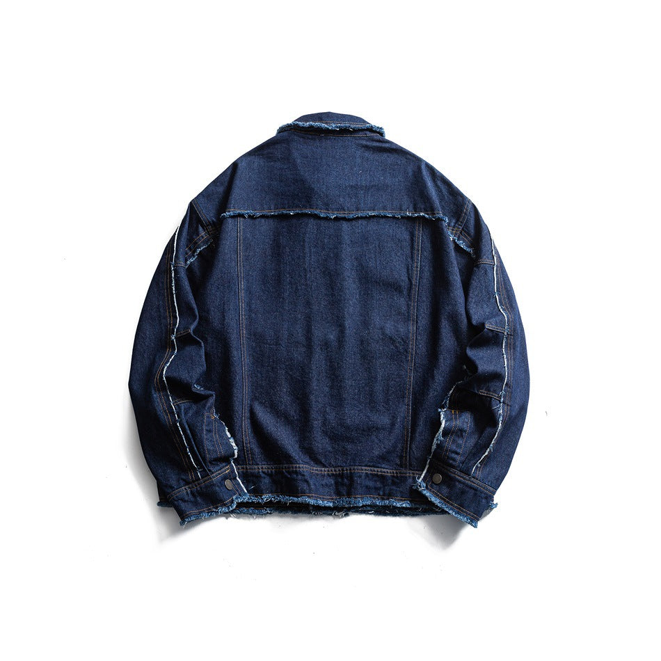 Back view of a dark indigo denim jacket with a horizontal yoke seam and frayed hem.
