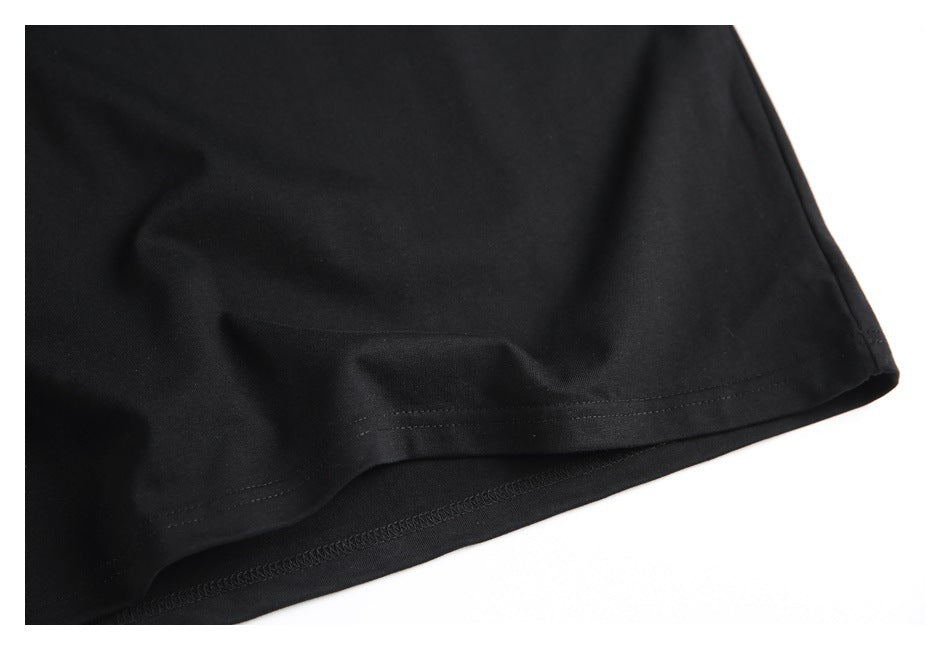Close-up of the lower hem and stitching on a black shirt.