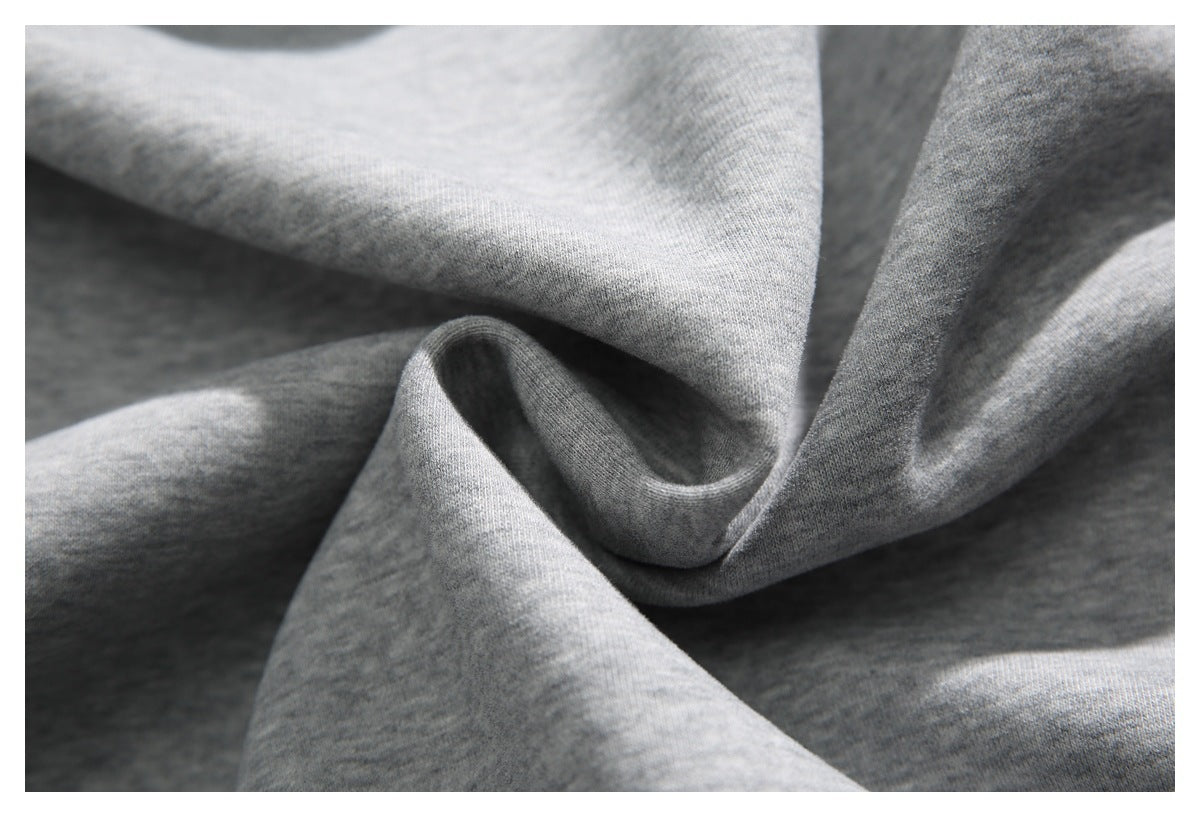 Close-up of softly draped heather gray knit fabric.