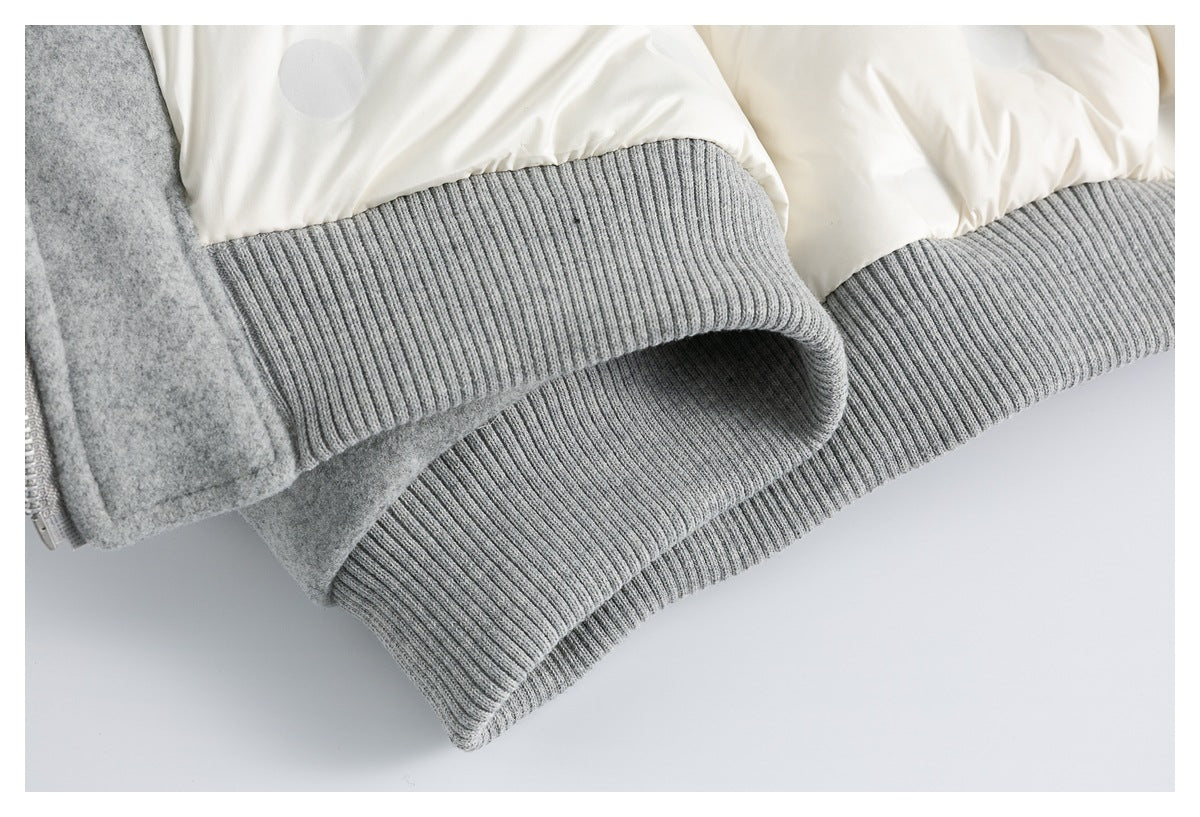 Close-up of a gray ribbed jacket cuff folded over the body, with cream lining visible.