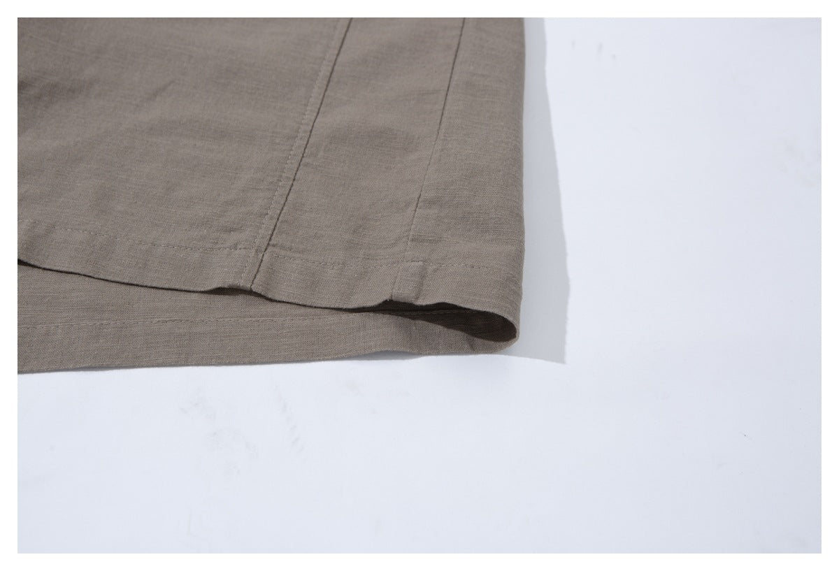 Close-up of the taupe shirt's lower hem and side seam.