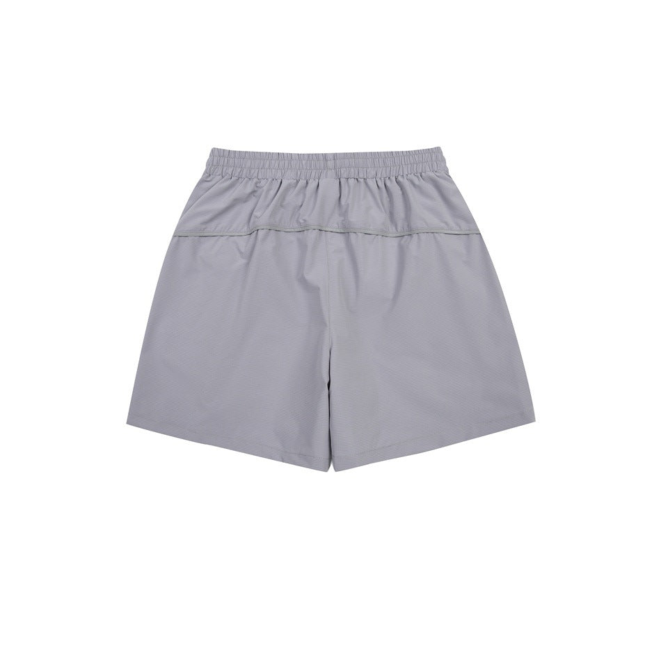 Light gray athletic shorts, back view, with an elastic waistband and horizontal yoke seam.