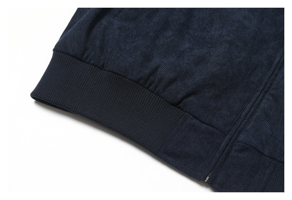 Close-up of the ribbed bottom hem of a dark navy garment.
