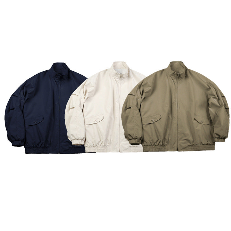 Three front views of the same high-collar zip jacket in navy, off-white, and olive, with flap pockets and elastic hems.