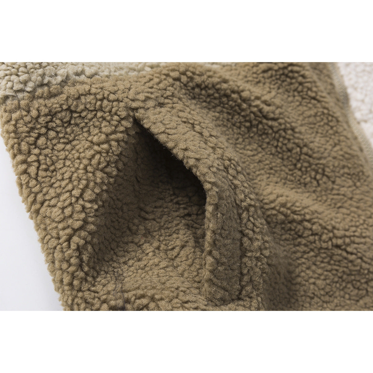 Close-up of a hand-warmer pocket opening on khaki textured fleece.