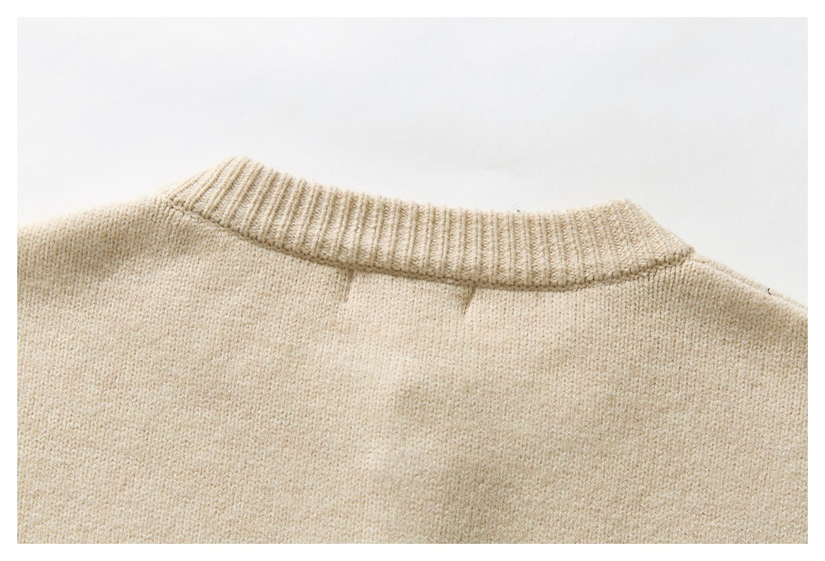 Close-up of the plain cream cardigan back and its ribbed neckline.