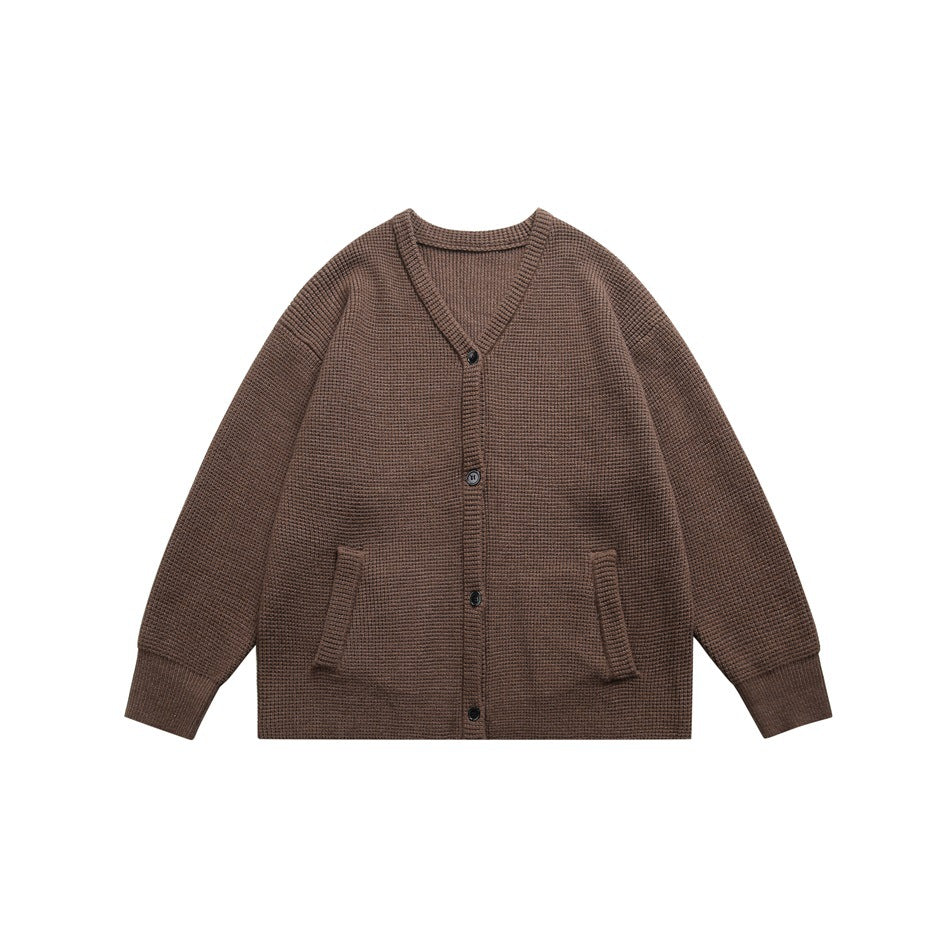 Brown waffle-knit V-neck button cardigan with front pockets and ribbed cuffs, flat lay front view