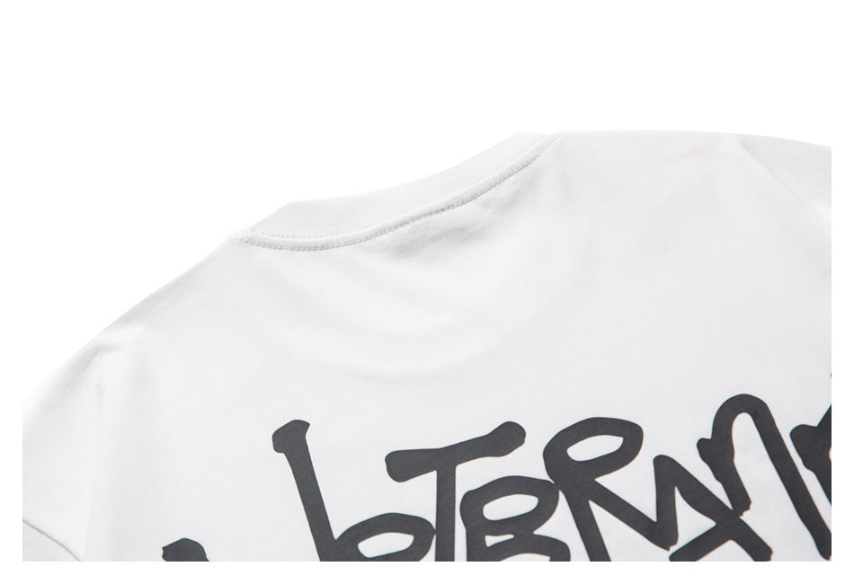 Cropped view of a large black handwritten-style graphic printed on the back of a white shirt.
