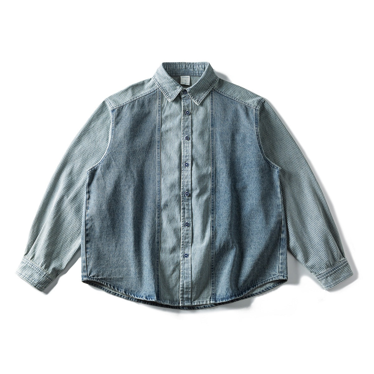 Flat lay of a blue washed denim button-front shirt with striped sleeves, collar and center panel