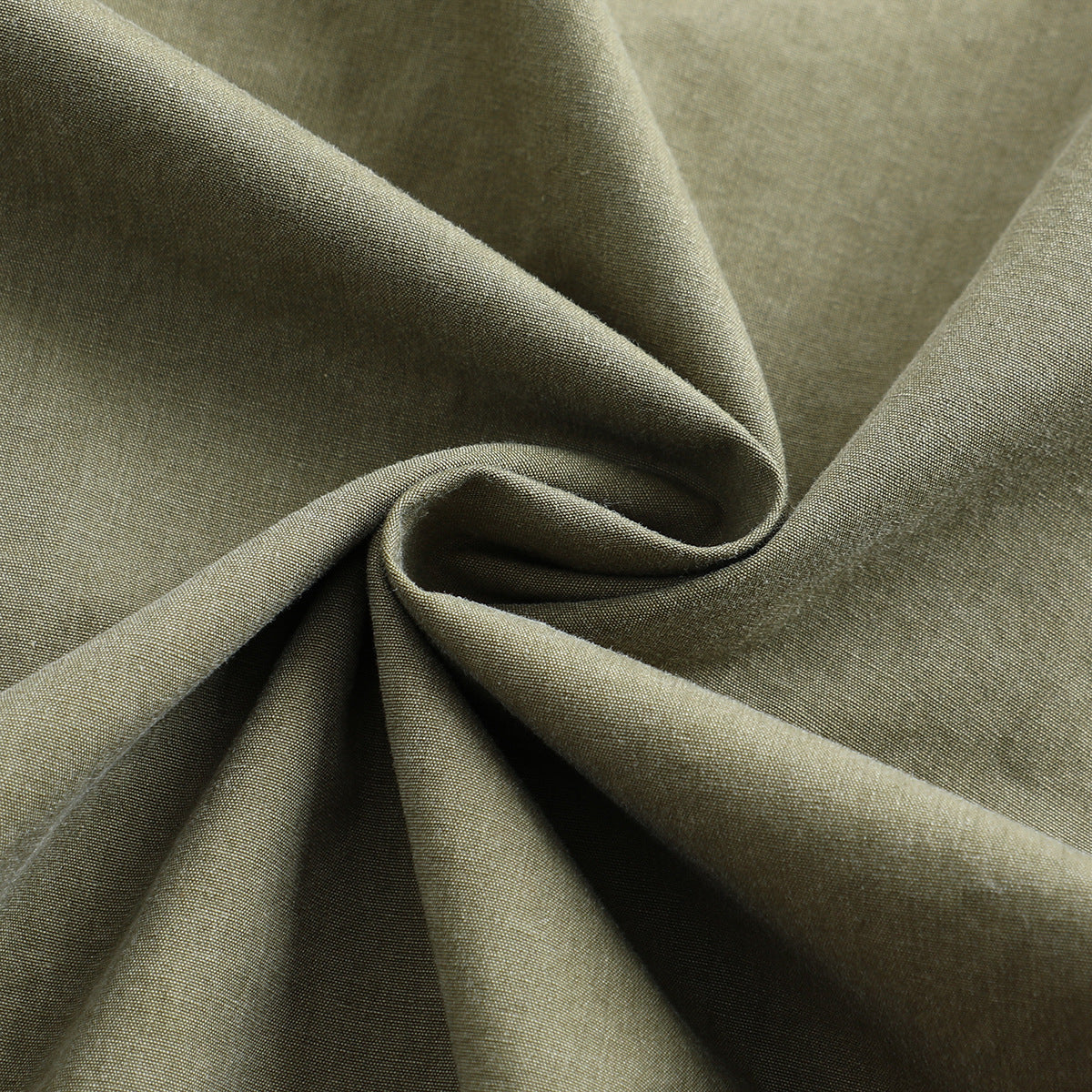 Close-up of olive-gray fabric draped into folds, showing its fine woven surface.