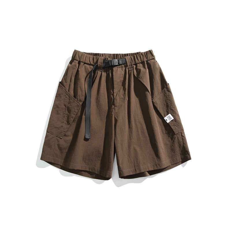 Brown knee-length shorts with elastic waist, dark buckle belt and large side patch pockets, flat lay