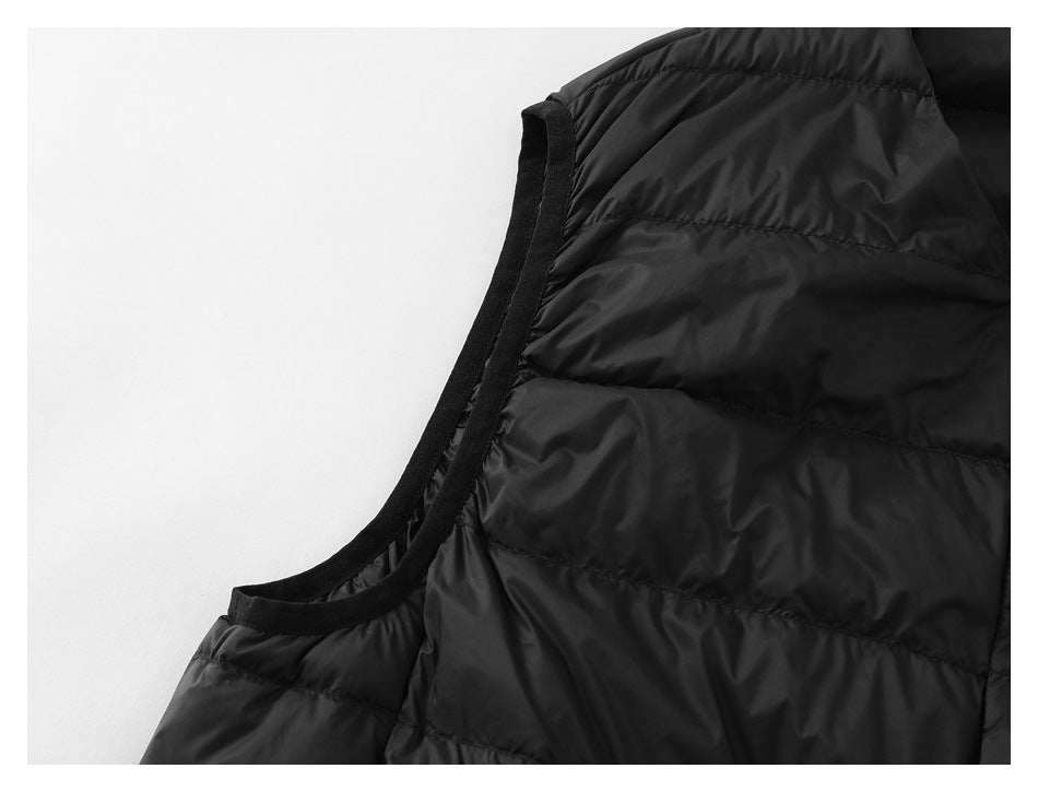 Close-up of the black vest's bound armhole edge and horizontal quilted panels.