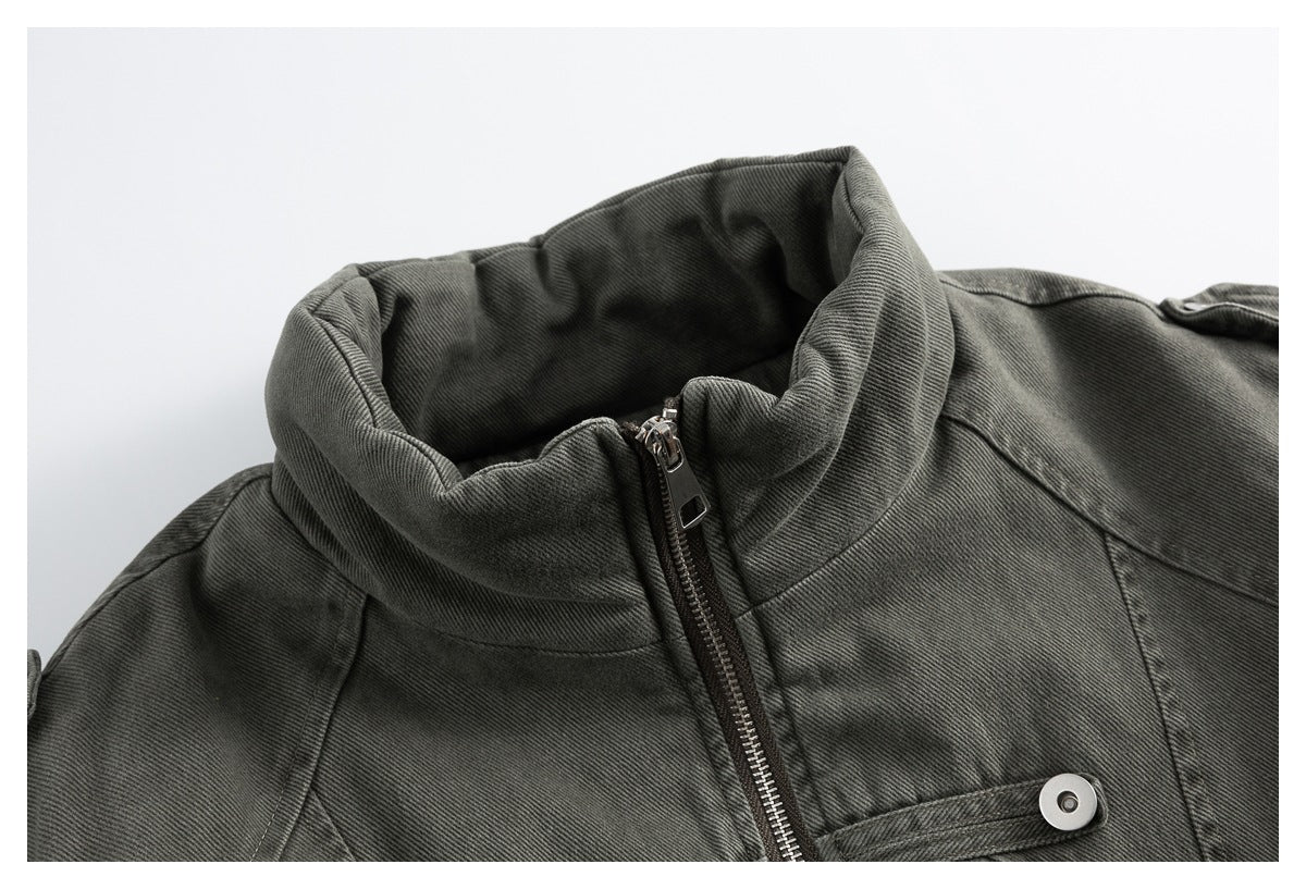 Close-up of a charcoal gray jacket collar, front zipper, and snap-fastened chest tab.