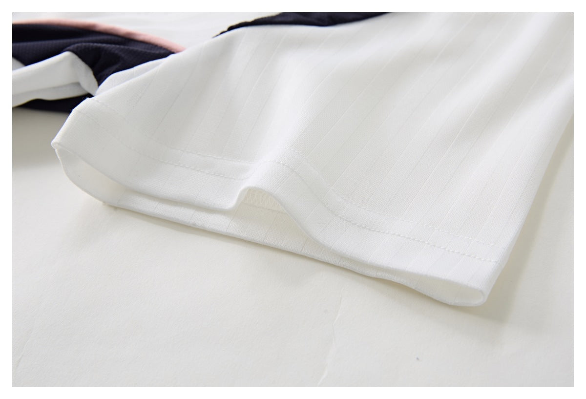 Close-up of the jersey's white pinstriped sleeve hem and navy-and-pink panel near the sleeve opening.