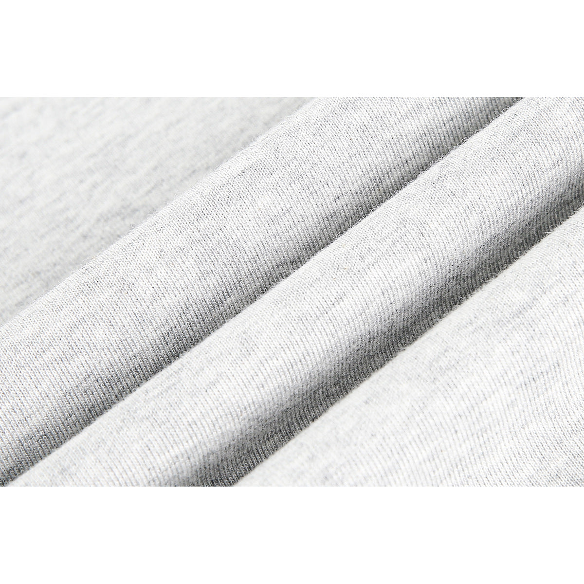 Extreme close-up of heather-gray knit fabric folded into soft ridges.