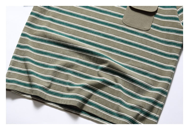 Close view of a khaki T-shirt with dark green and white horizontal stripes and a matching chest pocket.