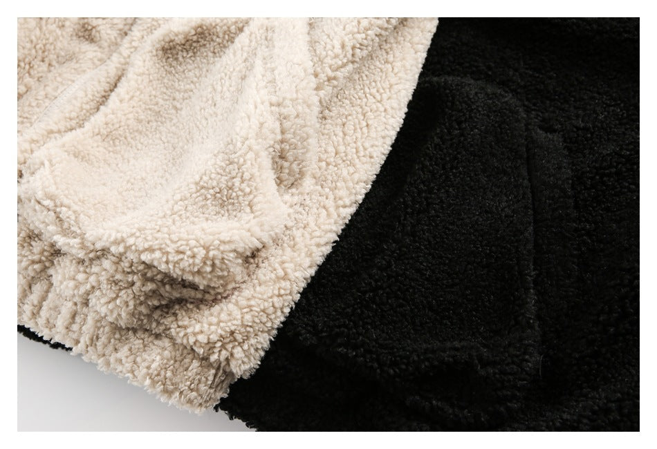 Close-up of cream and black fuzzy jacket fabric and pocket areas.