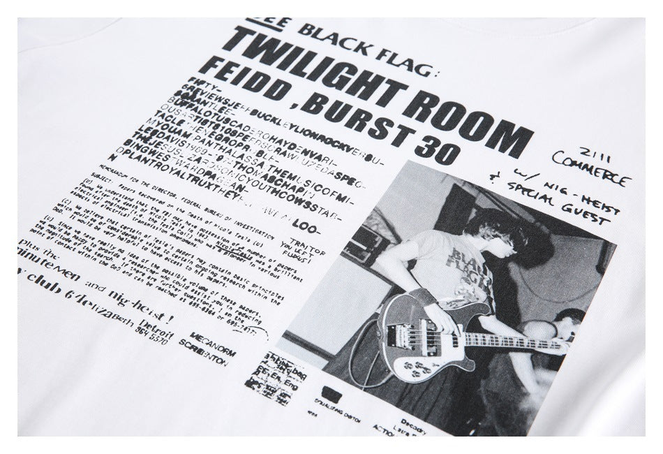 Close-up of a white T-shirt front with a large black text graphic and a black-and-white photo of a bassist.