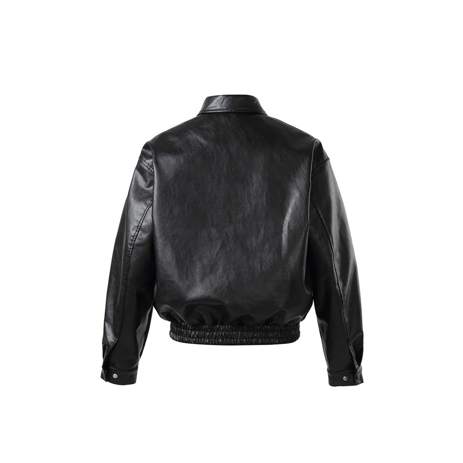 Back view of a black jacket with a pointed collar, long sleeves, and gathered hem.