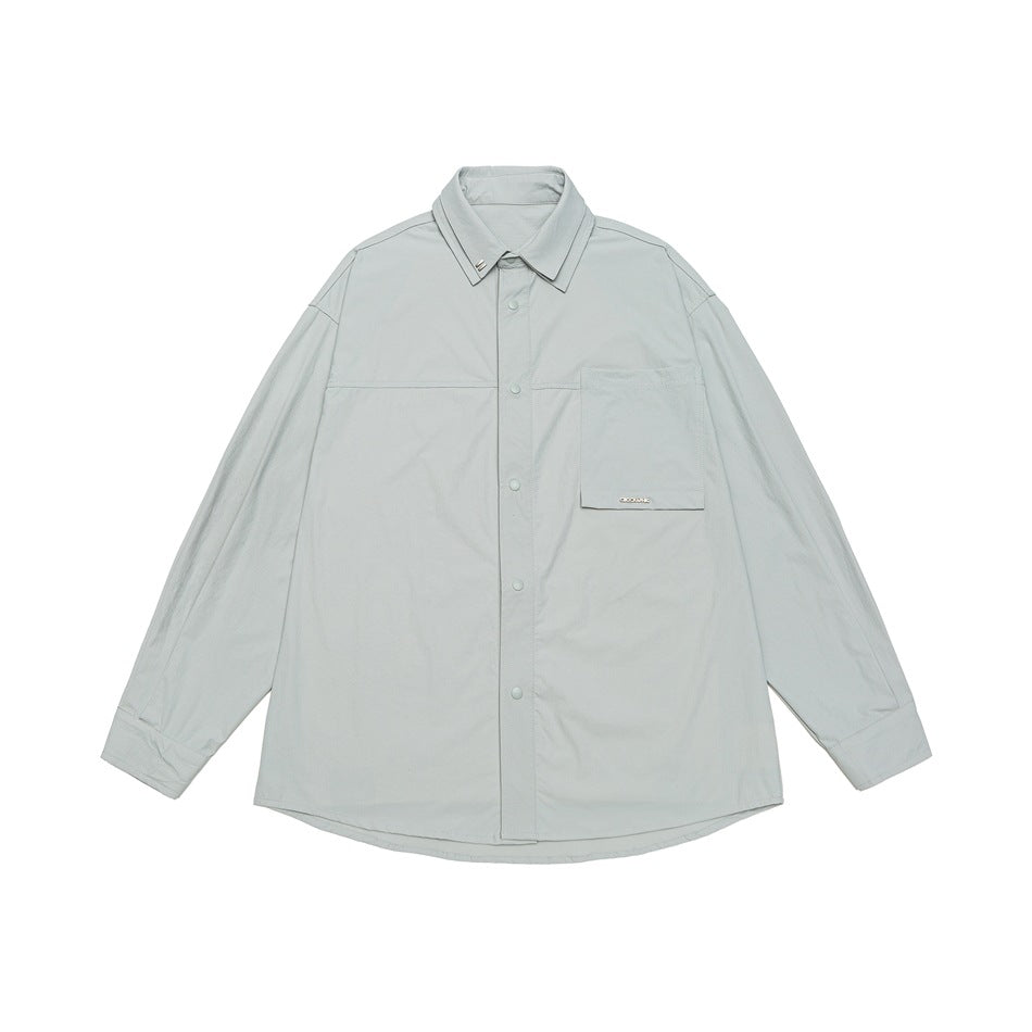Light gray long-sleeve snap-button shirt with double collar and large flap chest pocket, flat lay front view