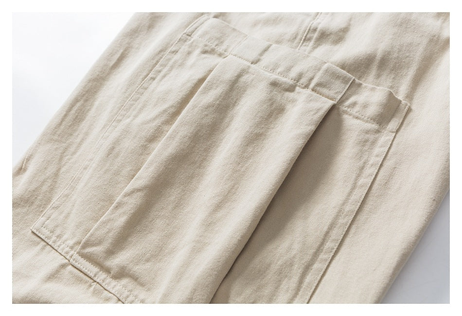 Close-up of a large rectangular patch pocket on beige pants.