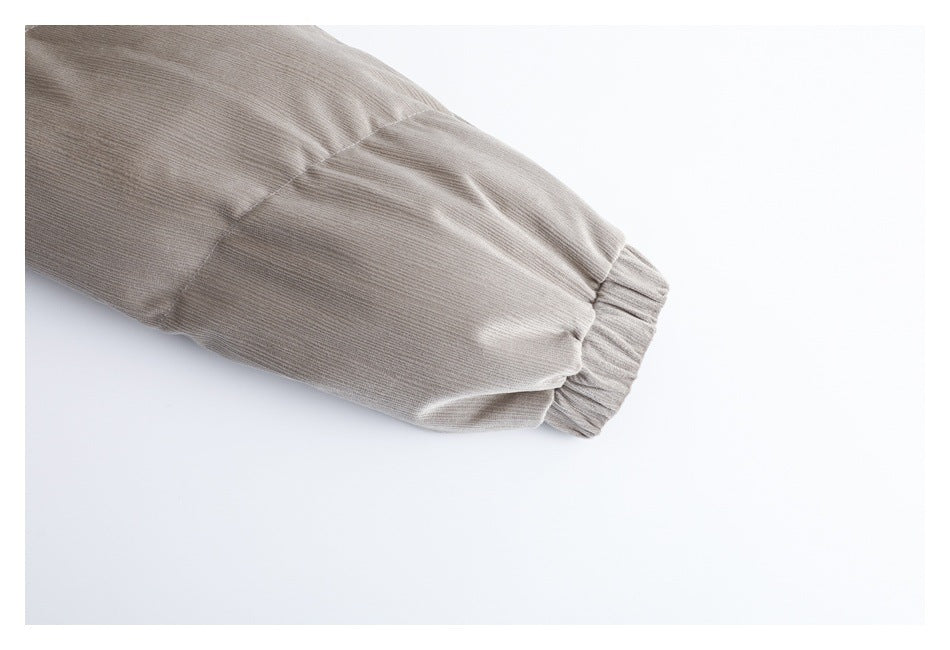Close-up of a taupe-gray garment sleeve ending in a gathered elastic cuff.