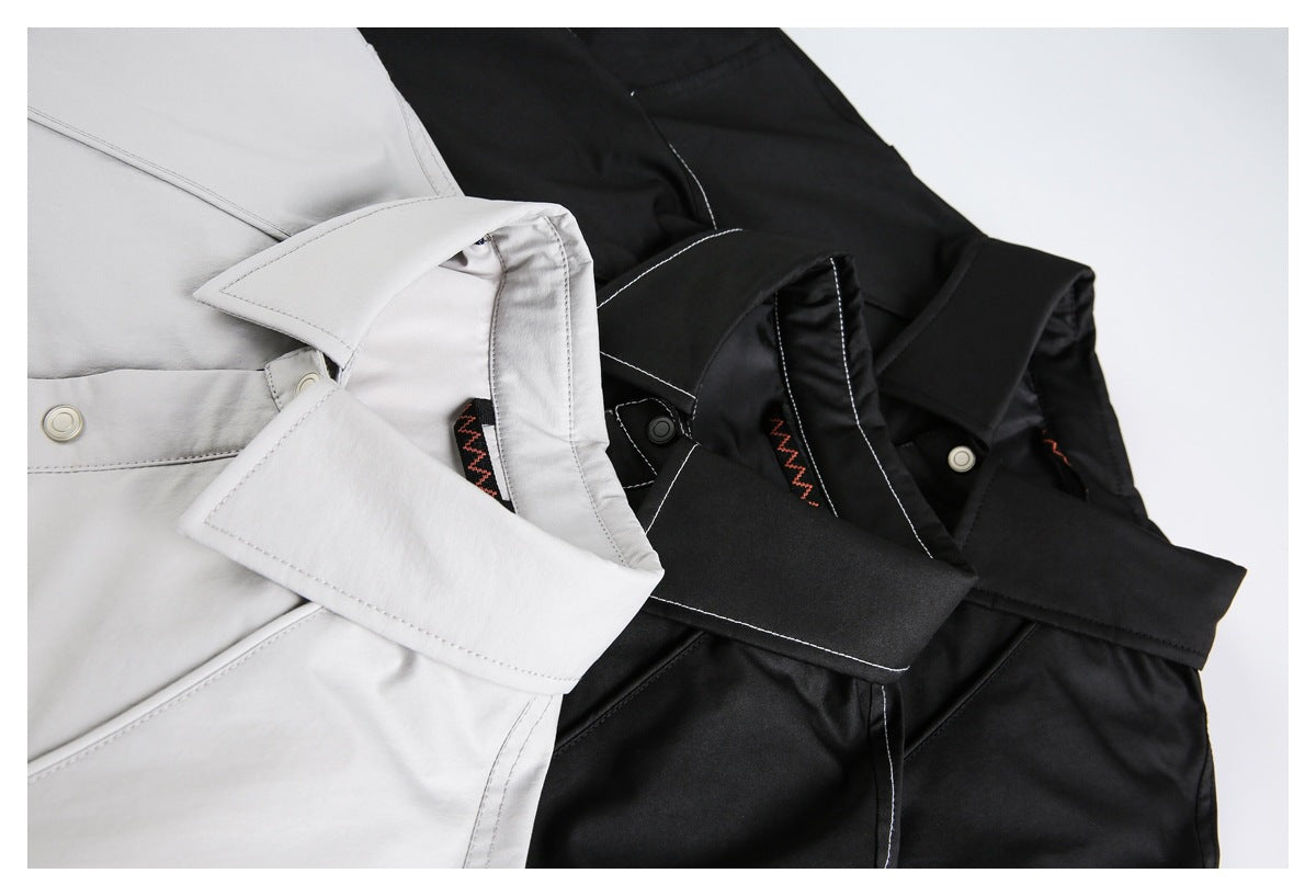 Close-up of black and light gray jackets showing wide collars, snap closures, and contrast stitching.