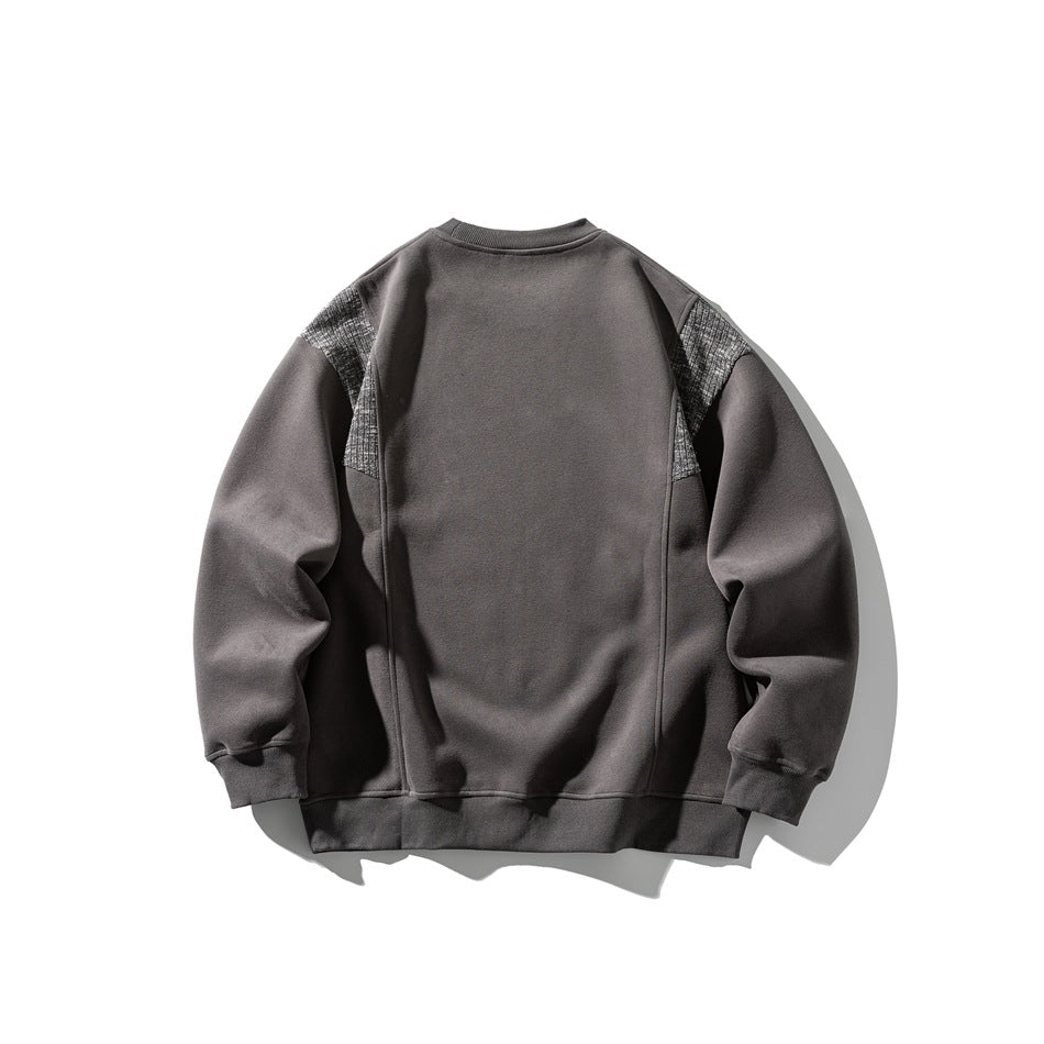 Back view of a charcoal gray crewneck sweatshirt with gray textured shoulder panels, shown flat against white.