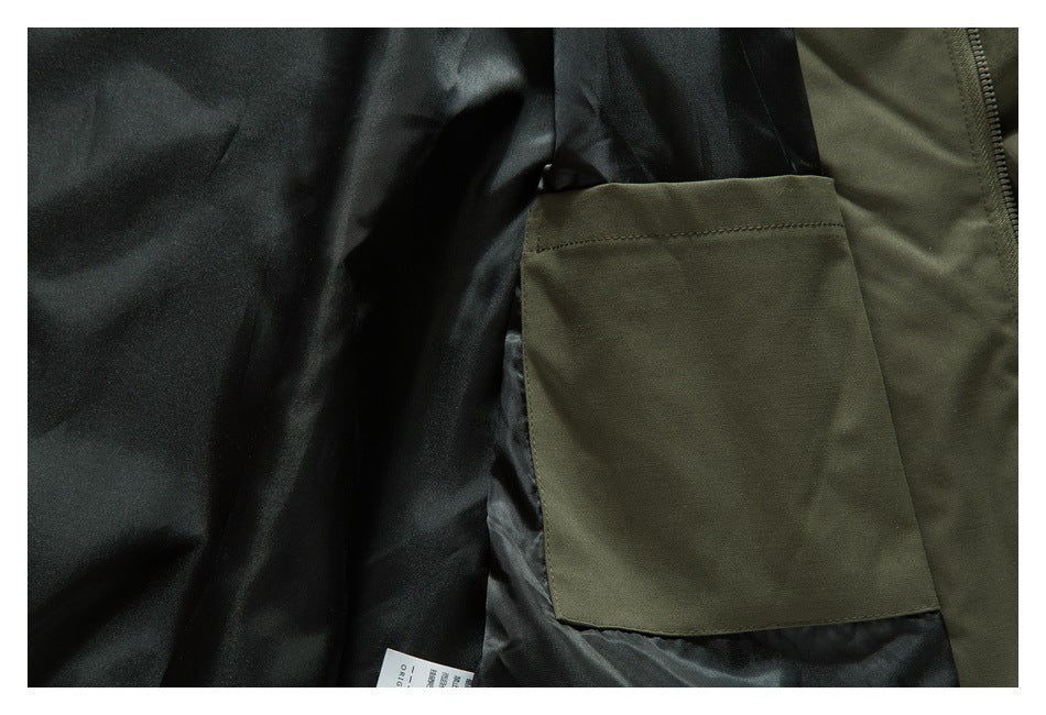 Close-up of an olive jacket's inner pocket against black lining, with a care label partly visible.