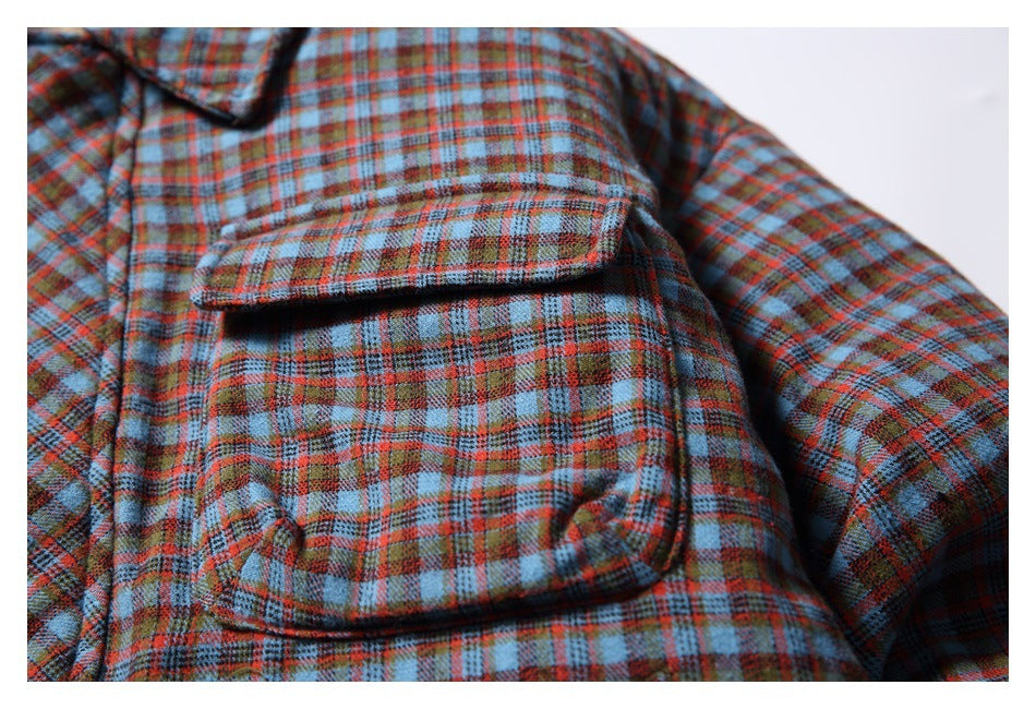 Close-up of the jacket's plaid flap chest pocket and surrounding fabric.