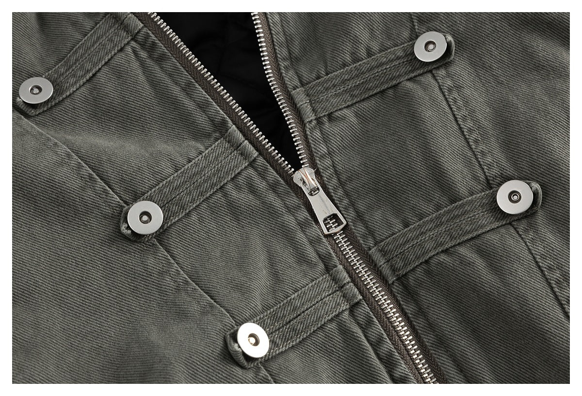 Close-up of the jacket front zipper and several narrow snap-fastened straps.