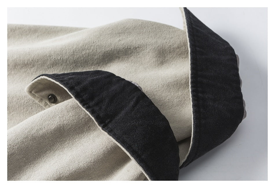 Close-up of the jacket's contrasting charcoal collar and beige fabric, with a metal snap visible.