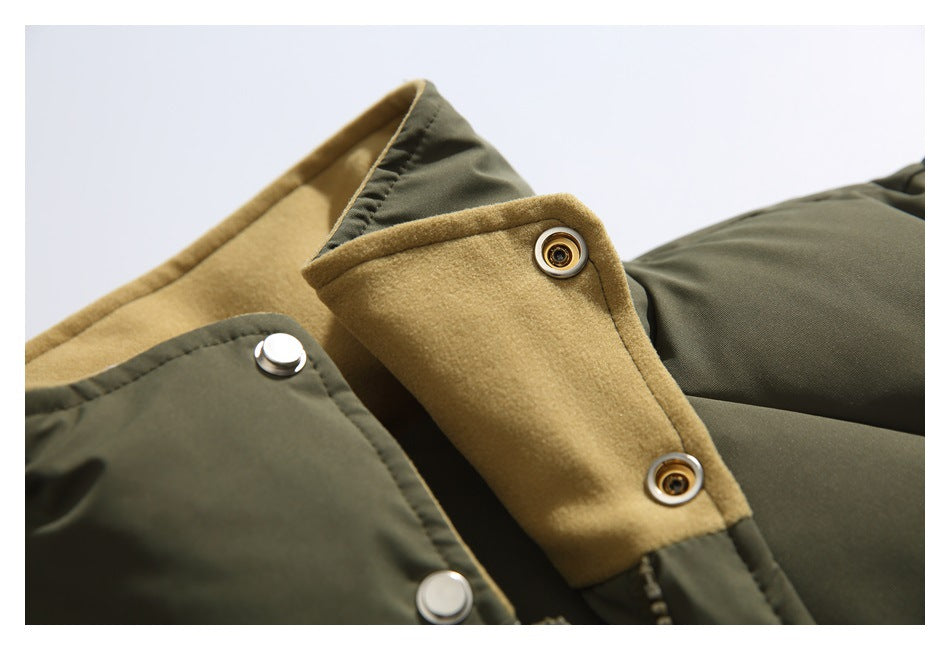 Close-up of an olive jacket’s tan inner facing and metal snap fasteners.