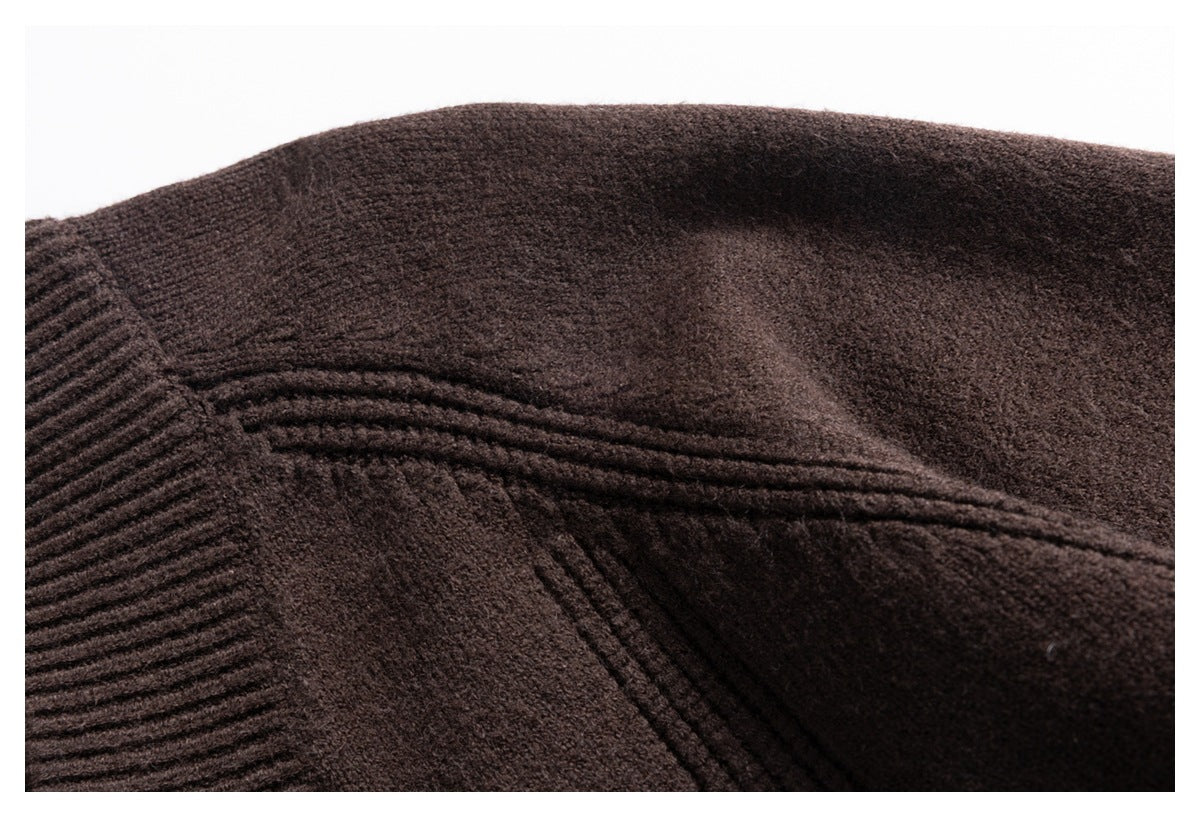 Close-up of a dark brown knit garment showing a seam and textured stitching.