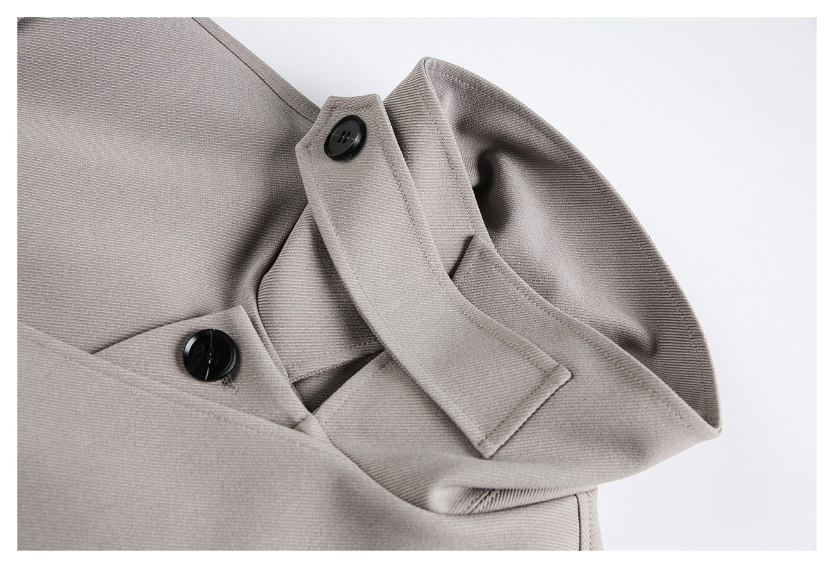 Close-up of a light gray sleeve cuff with overlapping buttoned tabs.
