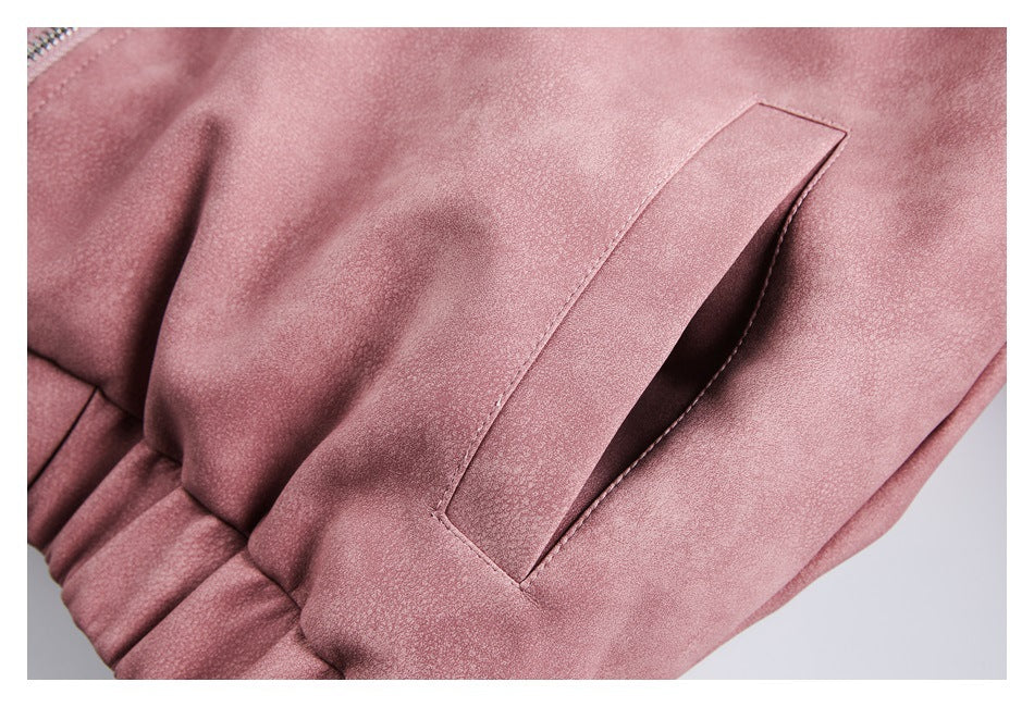 Close-up of a slanted welt pocket and gathered lower edge on a dusty rose jacket.