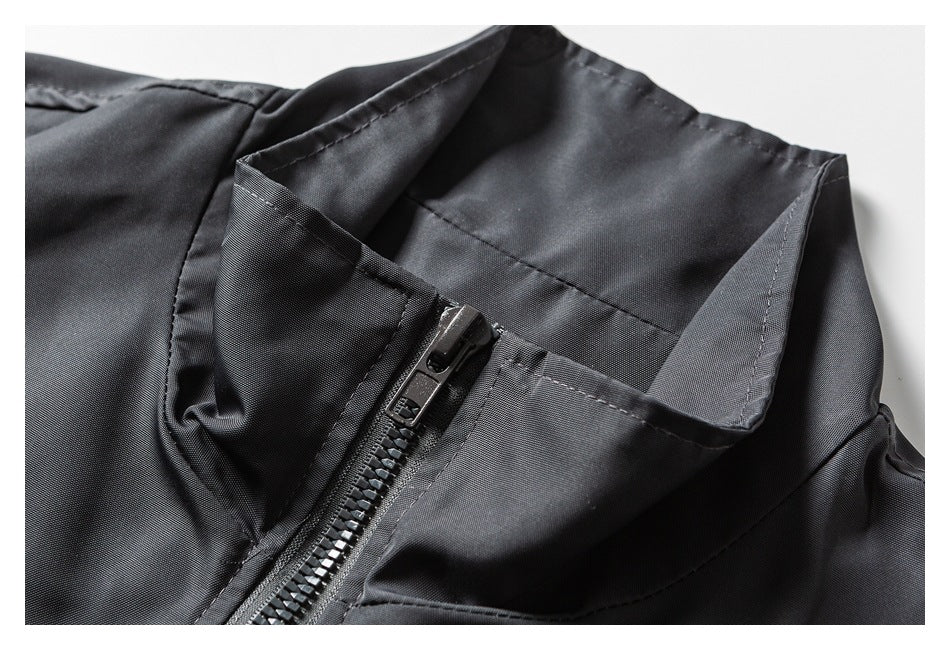Close-up of a dark charcoal jacket collar and front zipper.