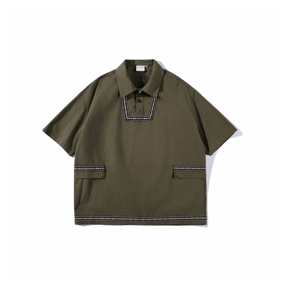 Olive green short-sleeve pullover shirt with collar, two buttons, woven geometric trim and flap pockets, flat lay