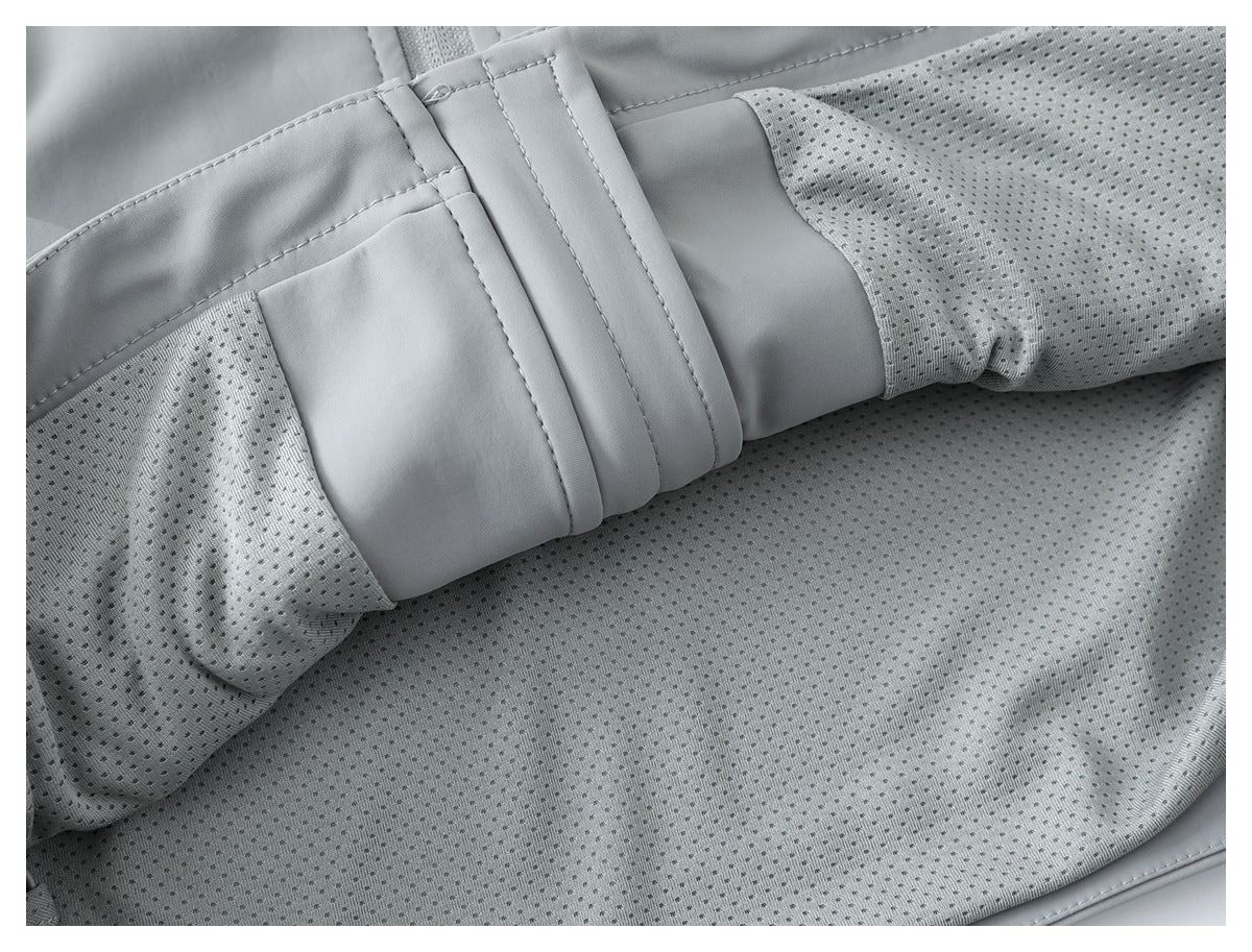 Close-up of the jacket's light gray perforated mesh lining and interior seam.