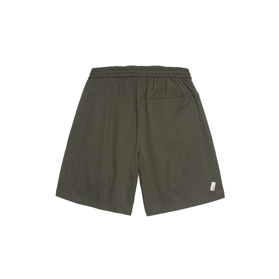 Back view of olive gray-brown shorts with elastic waistband, welt pocket and small side hem label