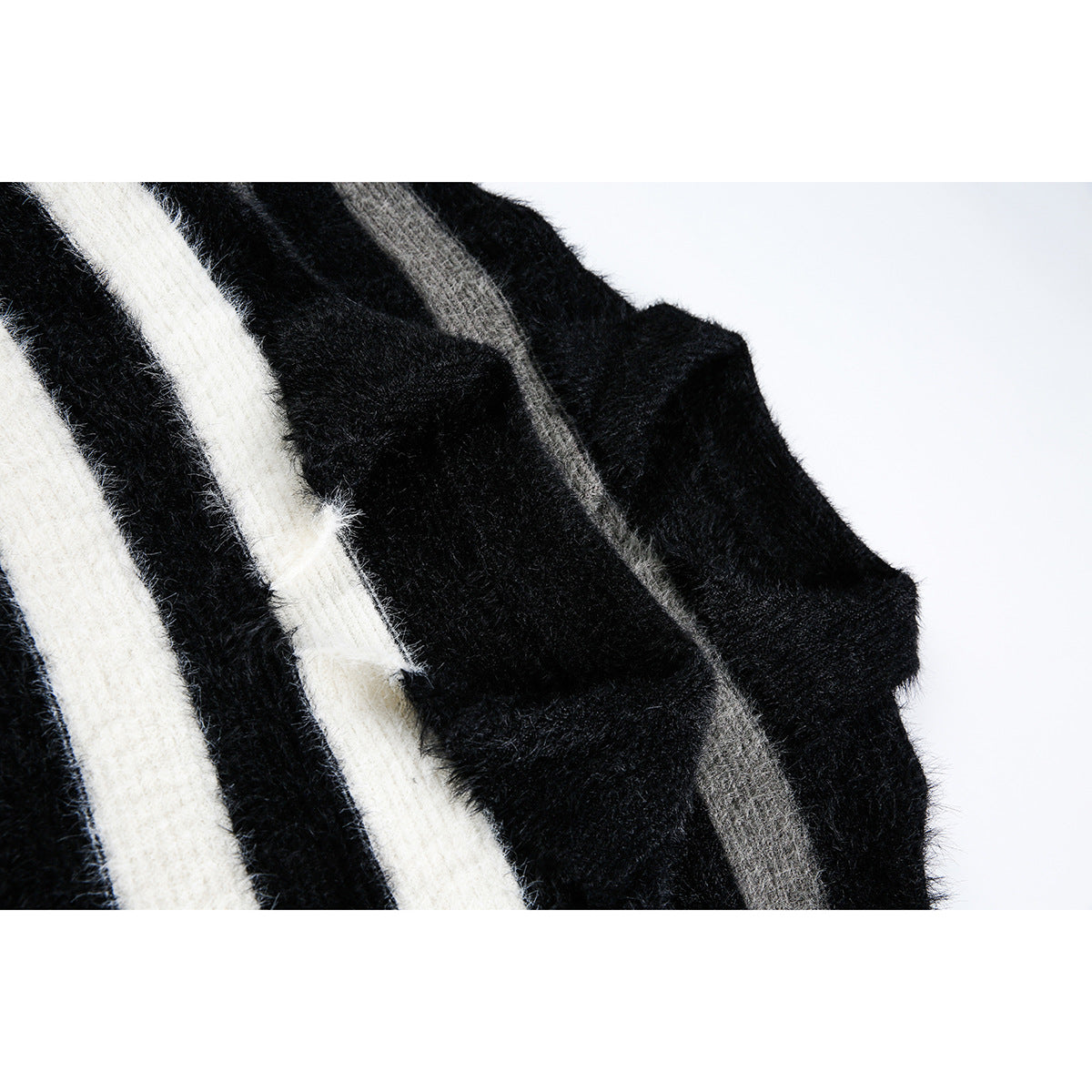 Close-up of fuzzy knit fabric with black, ivory, and gray stripes.