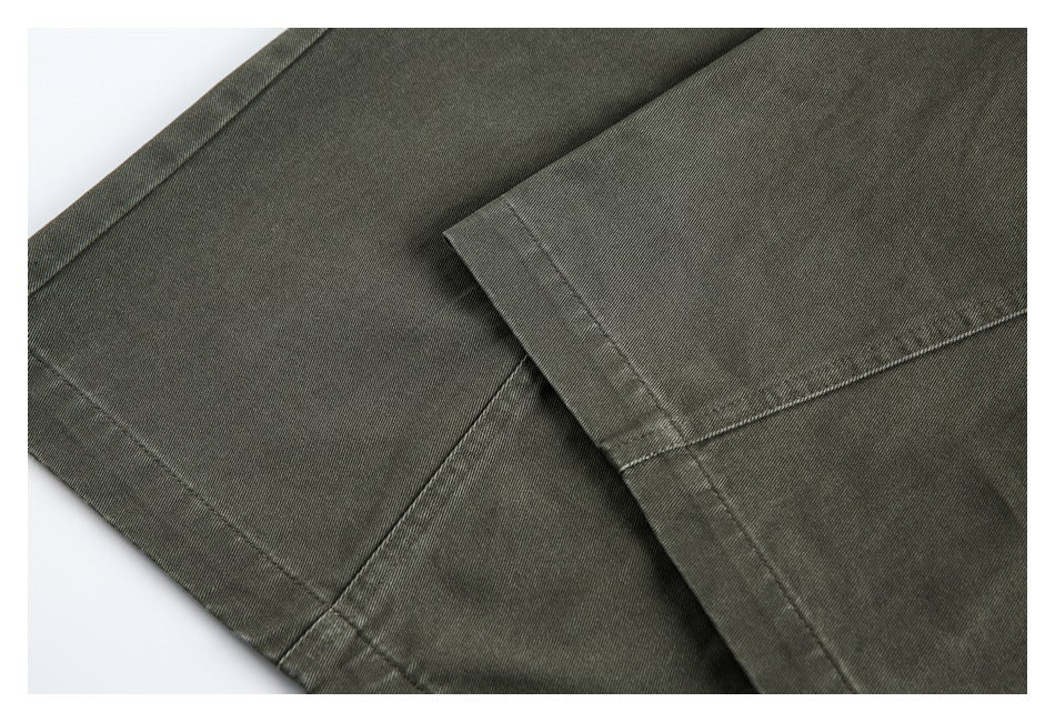 Close-up of olive-gray trouser legs showing the hem and seam stitching.