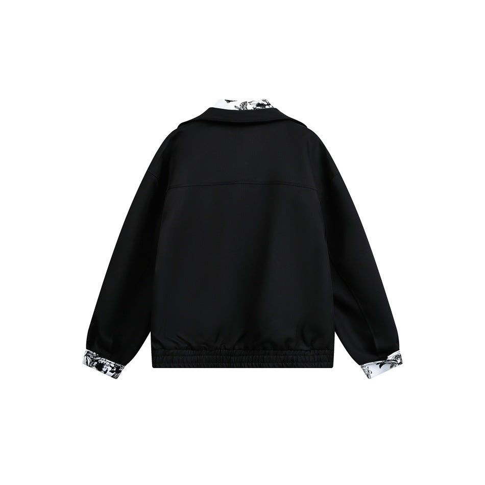 Back view of a black jacket with an elastic hem and black-and-white botanical print at the collar and cuffs.