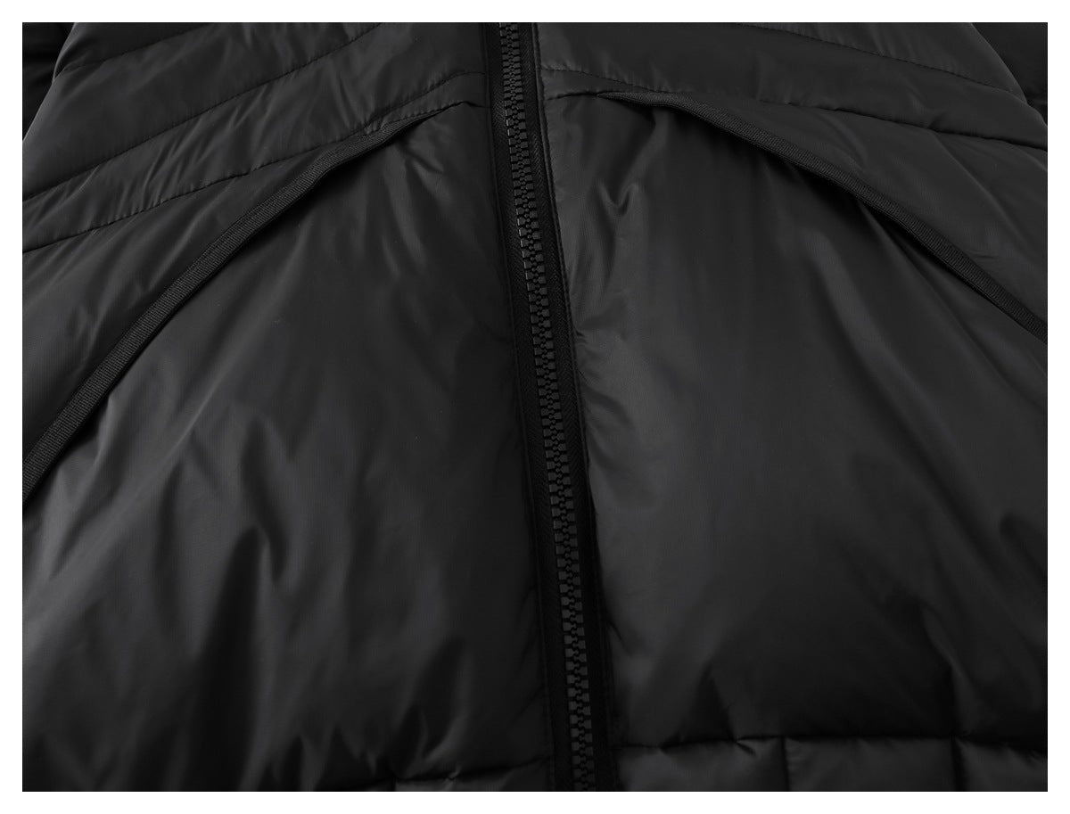Close-up of a black puffer jacket showing its center zipper and curved pocket openings.