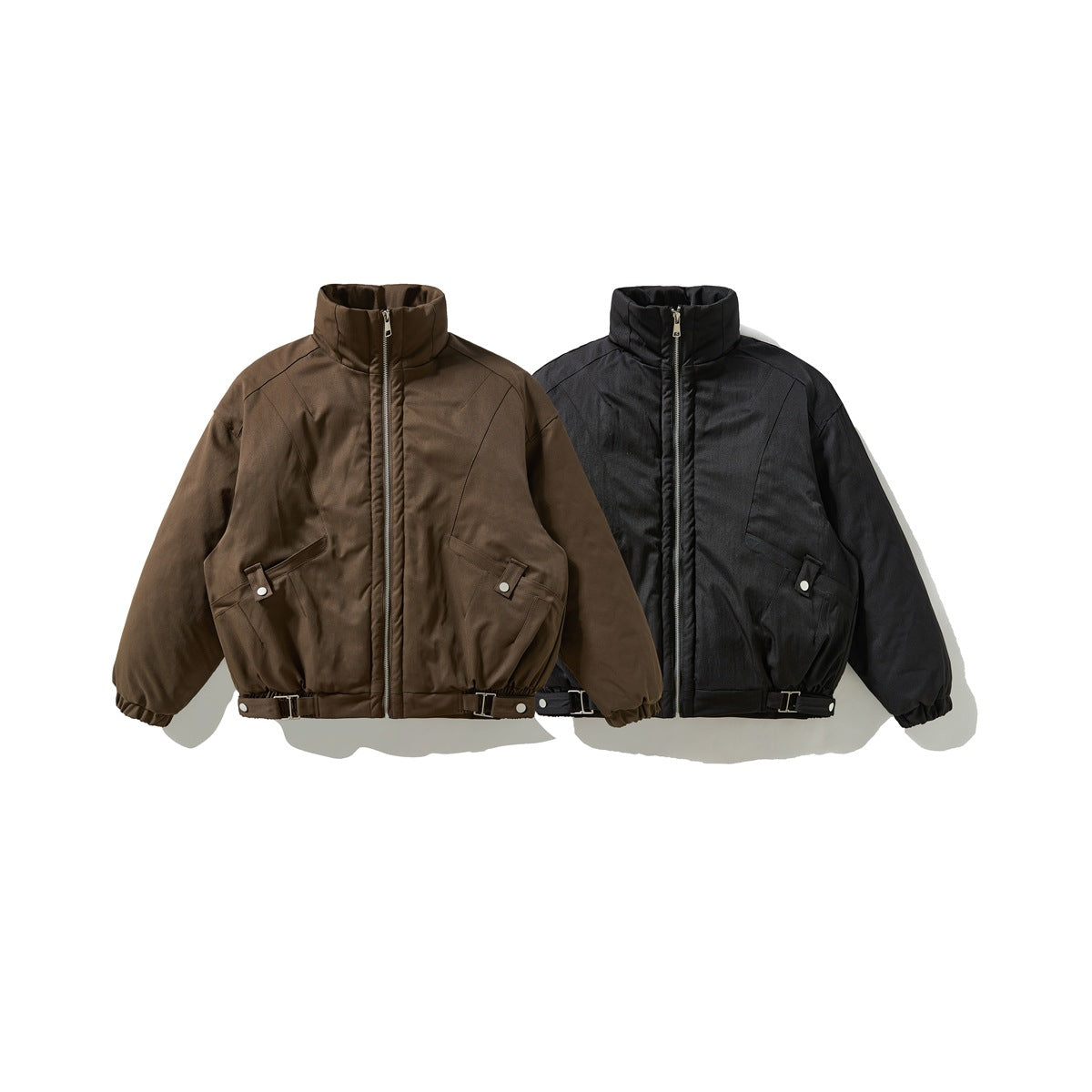Front view of two cropped jackets, one dark brown and one black, with stand collars, zippers, and adjustable hems.