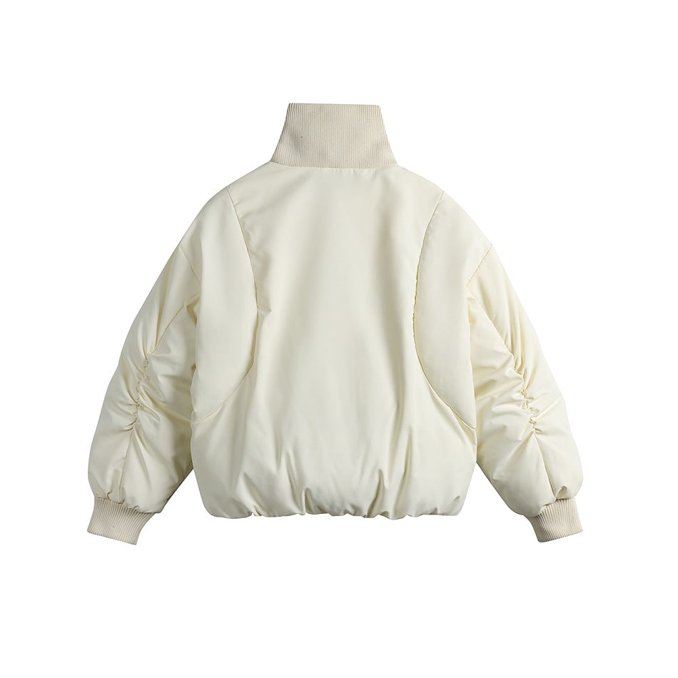 Back view of an ivory padded jacket with a tall knit collar, gathered sleeves, ribbed cuffs, and a gathered hem.