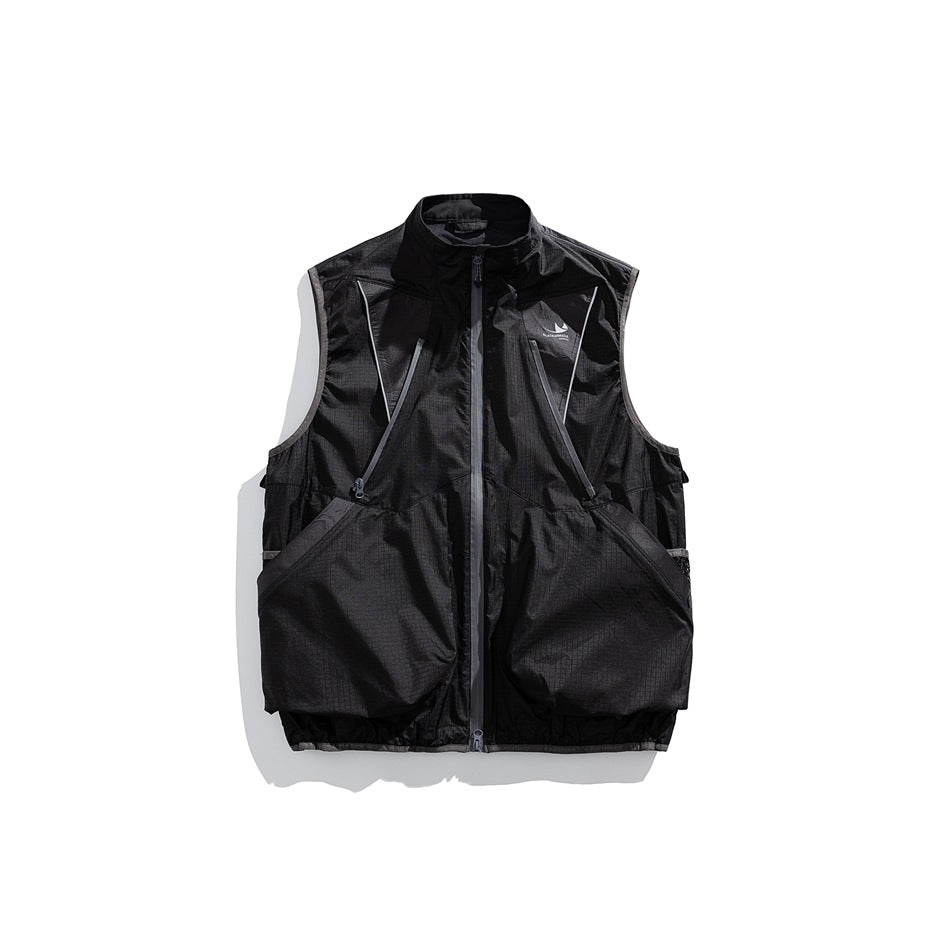 Black sleeveless utility vest with a zip front, angled chest zippers and large front pockets.